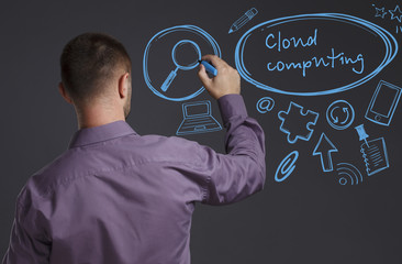 Business, Technology, Internet and network concept. A young businessman writes on the blackboard the word: Cloud computing