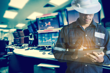 Double exposure of  Engineer or Technician man in working shirt  working with tablet in control room of oil and gas platform or plant industrial for monitor process, business and industry concept