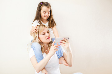 Indian mother and child playing game on the smartphone
