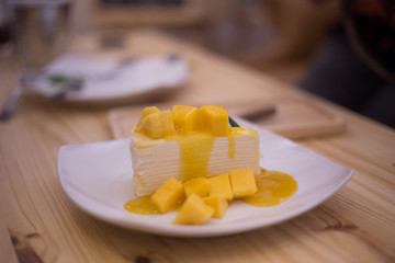 Mango cake delicious yellow in Ceramic plate.