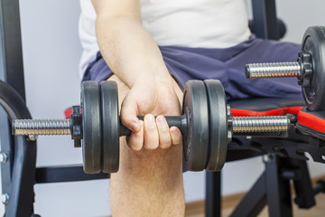 Man doing exercise with dumbbell for arms