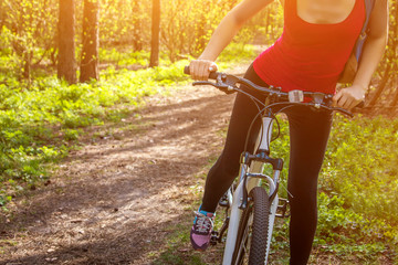 Young woman riding a bicycle in the forest