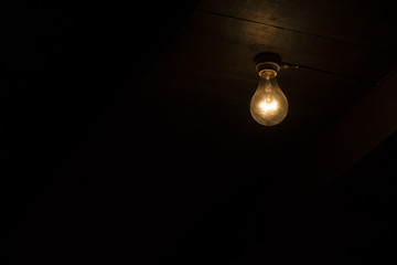 close up of a tungsten lightbulb in wood house