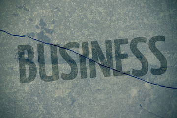 Inscription Business on a crack in concrete - a concept of bankruptcy