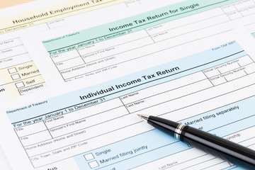 Tax form with pen; document are mock-up