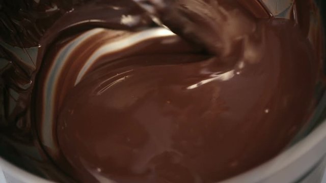 close up shot of Chef baker mixing sweet delicious organic melted chocolate in bowl