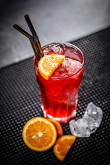 Red cocktail with orange slice