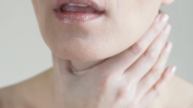 Woman is sick and coughs, sore throat, close-up