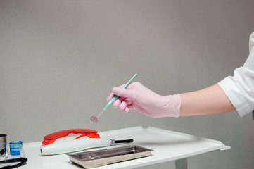 Dentist doctor hand holding dentist tools in Dentist Clinic