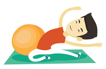 Young man exercising with fitball.