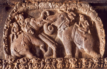 Elephant riders carved on stone wall inside the 7th century temples in Pattadakal, India. UNESCO World Heritage site