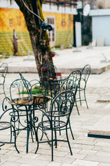 Fototapeta na wymiar Tables in cafe on the street. Street Cafe. Restaurants in Montenegro.