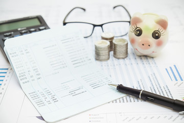 Row of coins,pen and calculator with account book finance and banking concept for background.concept in grow and walk step by step for success in business. concept of saving money.