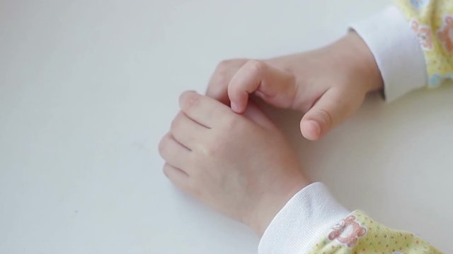 Hands of a child on a white background.