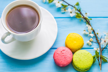 Stil life with macarons and coffee on the wooden background