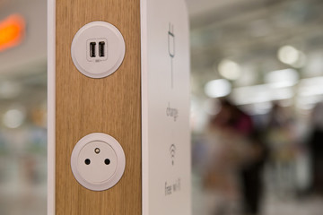 Modern power socket in a public place - usb charger ports on decorative panel. Free wifi. Concept of new technologies