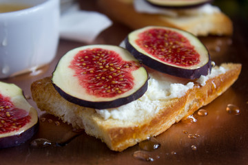 Bruschetta with goat cheese and figs on copper tray