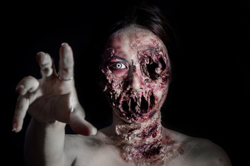  horrible scary zombie girl on black background with copyspace - obrazy, fototapety, plakaty