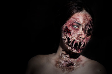  horrible scary zombie girl on black background with copyspace