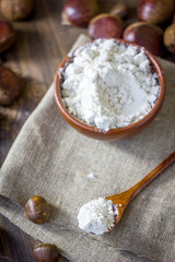 Natural organic chestnut flour in brown ceramic bowl.