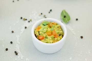 Traditional mexican avocado - vegetarian dip surrounded by its ingredients.