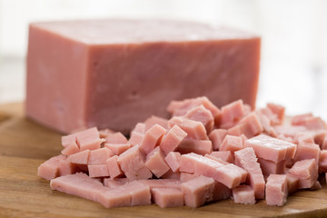 Chopped ham on the wooden board with backlight