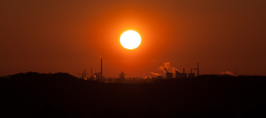 sunset behind industrial landscape, Ruhr-Area Germany