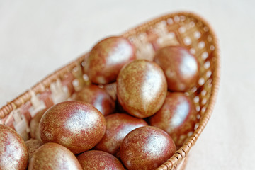 Golden Easter eggs in a wicker basket. Holiday food.