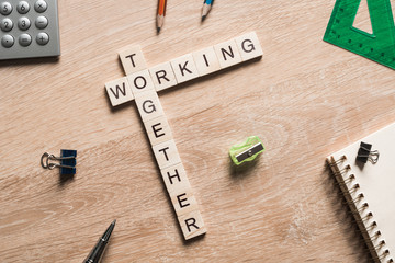 Working together words collected of game cubes on wooden surface