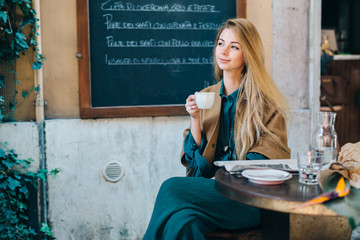 Cafe table young woman drinking coffee lifestyle blackboard background - 144643170