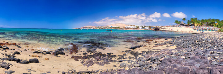 View to Costa Calma sandy beach with vulcanic mountains in the background on Fuerteventura island, Canary Islands, Spain.