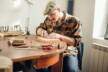 Man working with leather using crafting DIY tools