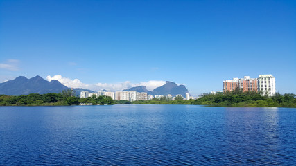 Fototapeta premium View of lagoon in Barra da Tijuca with mountains and buildings in the background in Rio de Janeiro Brazil