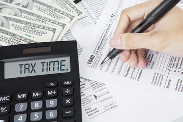 Hands of businessman filling out tax forms