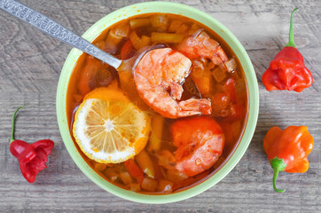 Soup with shrimp, lemon and spices. Top view, selective focus