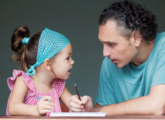 Father schooling his young daughter 