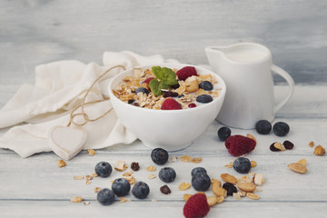 Bowl of homemade granola with yogurt and fresh berries