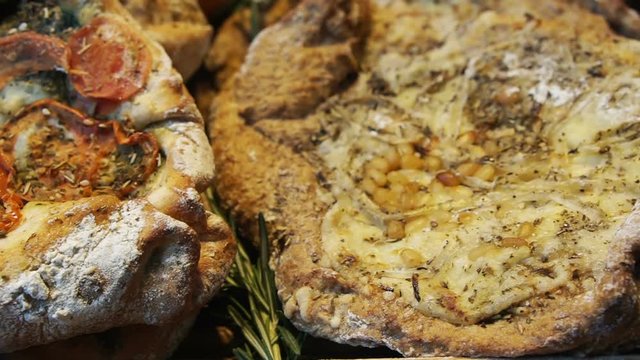 Lebanese style big flat bread baked and seasoning with different topping looks like pizza