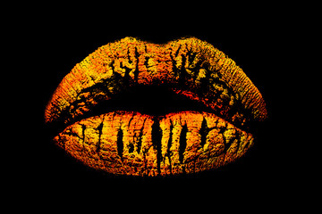 Golden lips isolated on black background. Print or trace from the lips, sensual royal kiss, female mouth in Egypt style. Cosmetics concept, creative chic and luxury makeup. Gold fashion lipstick trend