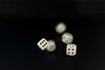 dice roll in flight on black matte background