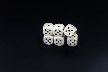 Dice six fives on a black matte background