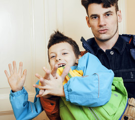 young handsome father with his son fooling around at home, lifestyle people concept 