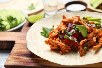 Delicious taco with tequila lime chicken on wooden board