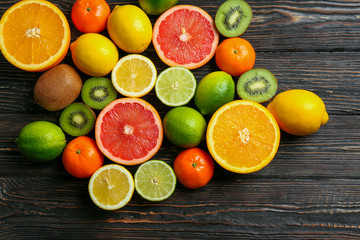 Beautiful composition of tropical fruits on wooden background