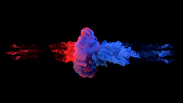 Color paint drops in water in slow motion. Ink swirling underwater. Cloud of silky ink collision isolated on black background. Colorful abstract smoke explosion animation. Close up camera view.