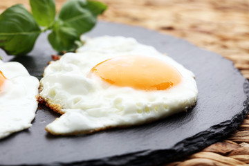 fried eggs with basil pepper and salt