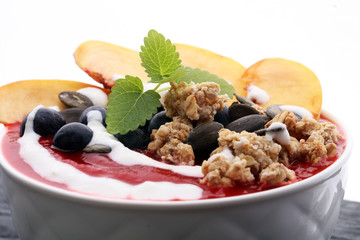 breakfast smoothie bowl with blueberries, peach and granola