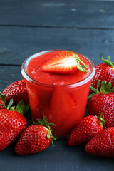 Fresh strawberry smoothie on wooden table
