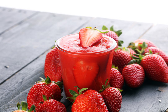 Fresh strawberry smoothie on wooden table