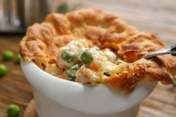 Delicious chicken pot pie on table, closeup